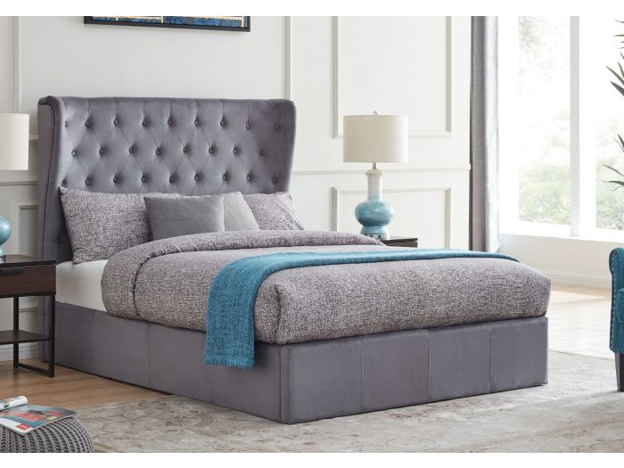 A luxurious grey upholstered ottoman bed frame with a buttoned, wing back headboard.