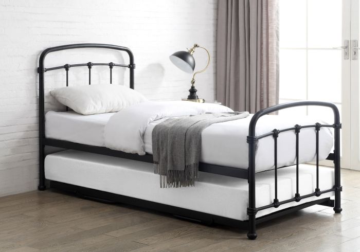 Black metal Victorian style guest bed with pull-out under bed. Curved headboard and footboard.