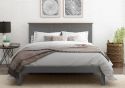 A classic style grey painted wooden bed frame with a panelled headboard and low foot end. Solid smoked oak plinth.