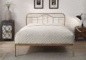 Antique bronze metal bed frame with a curved headboard and low foot end. Elegant, minimal design