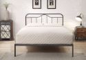 Black and silver metal bed frame with a curved headboard and low foot end. Elegant, minimal design