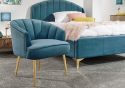 Elegant deep cushioned fabric chair with angled gold legs available in grey, teal, royal blue and pink